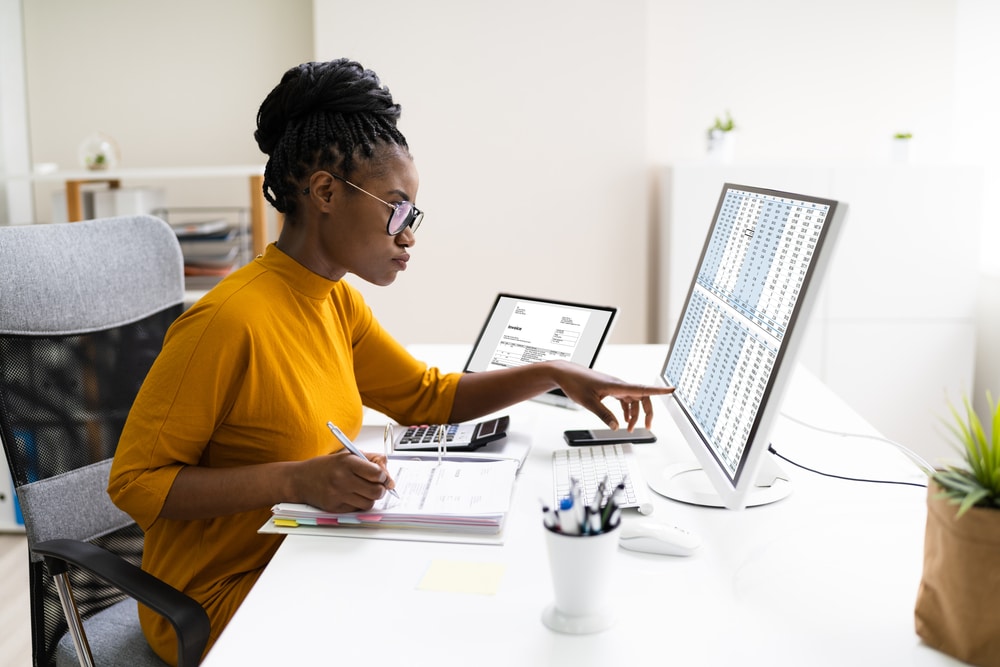 woman working with spreadsheets on computer