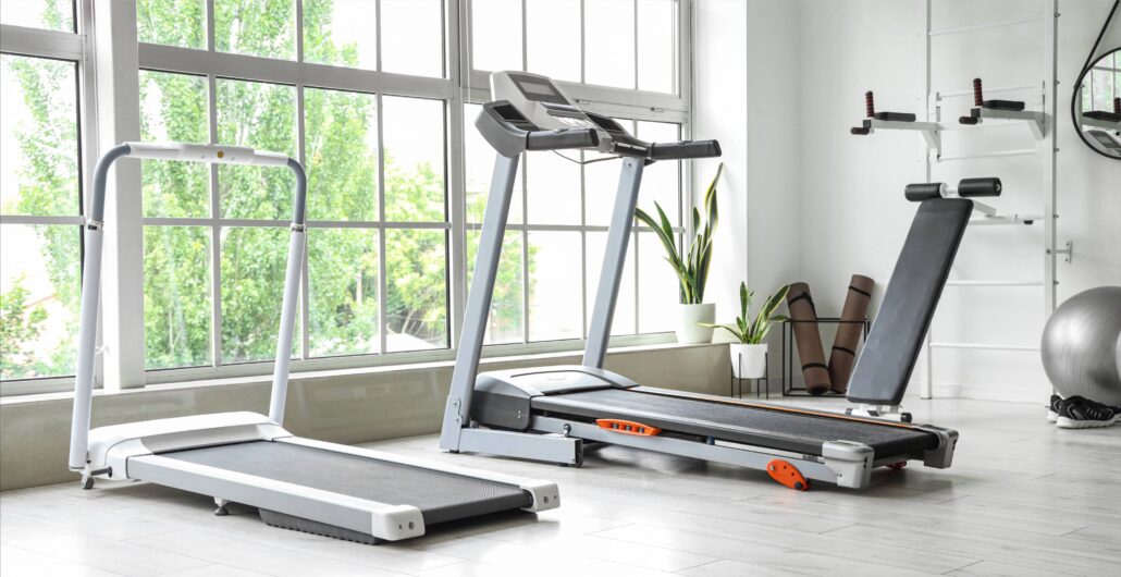 Home gym featuring treadmills and Amenity - workout equipment in a bright, plant-filled room.